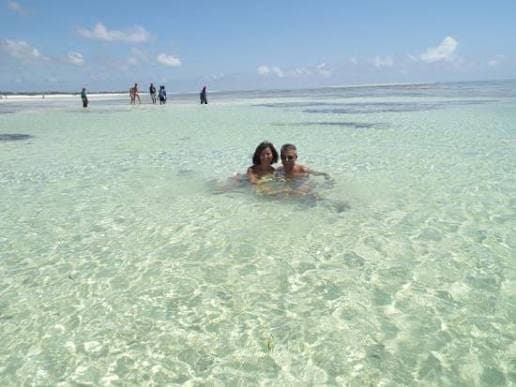 A couple embracing in the clear turquoise waters of the Indian Ocean